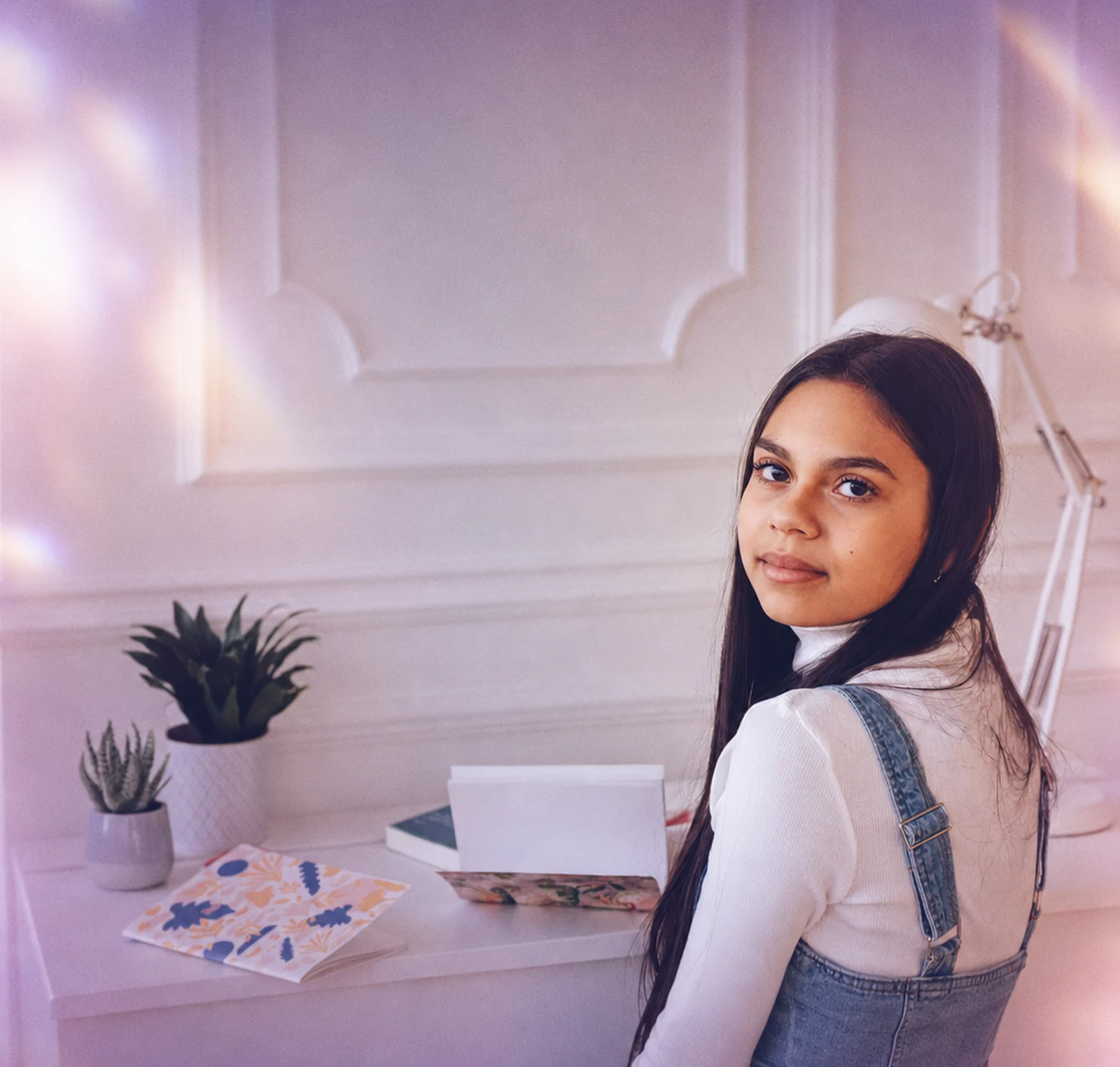 A teenager studying at a desk at home
