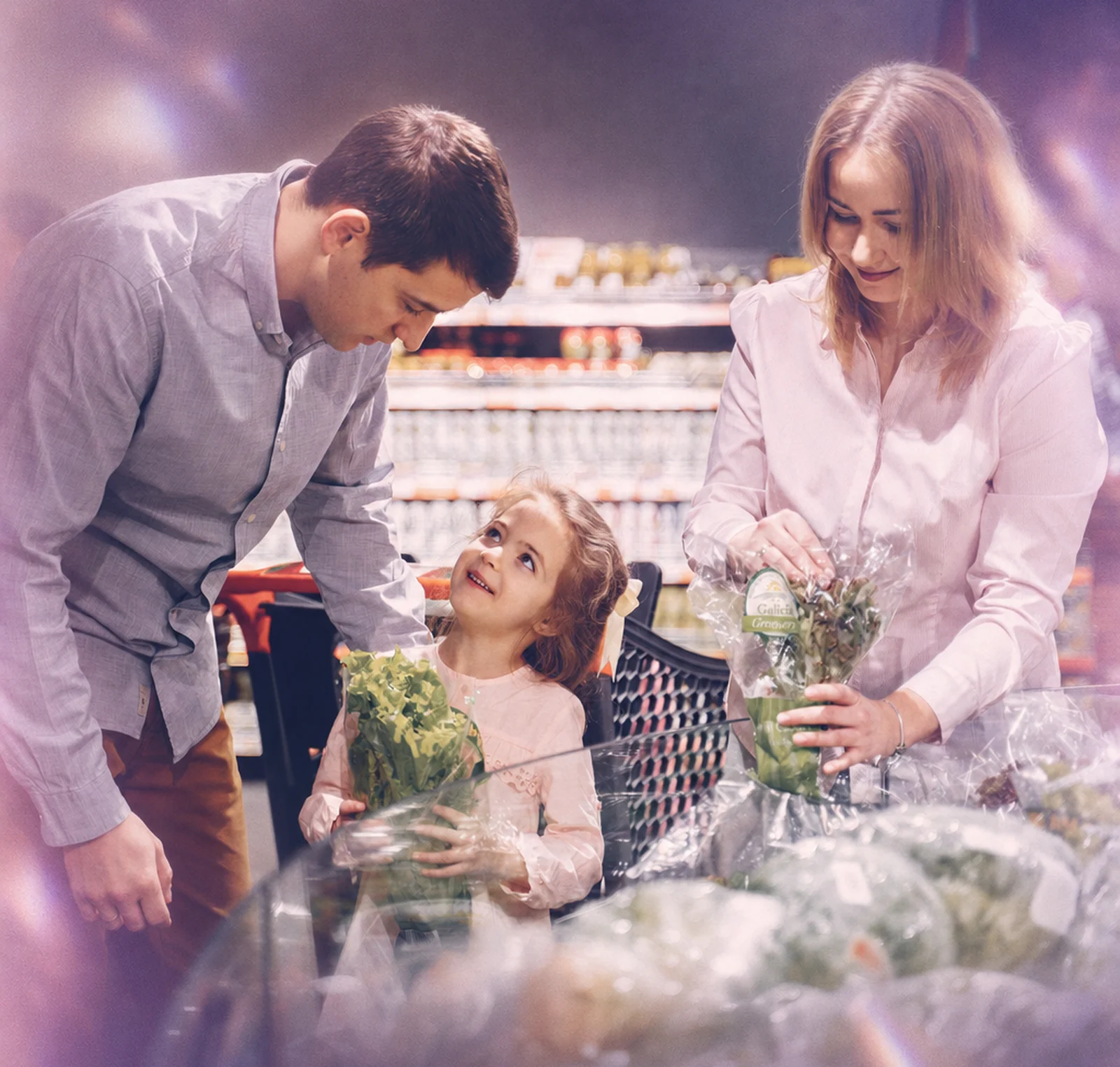 A family shopping for fruit together in a supermarket
