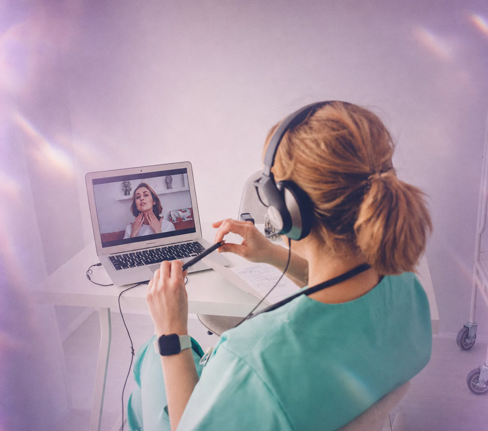 A parent waving during a virtual ABA session while her toddler plays beside her