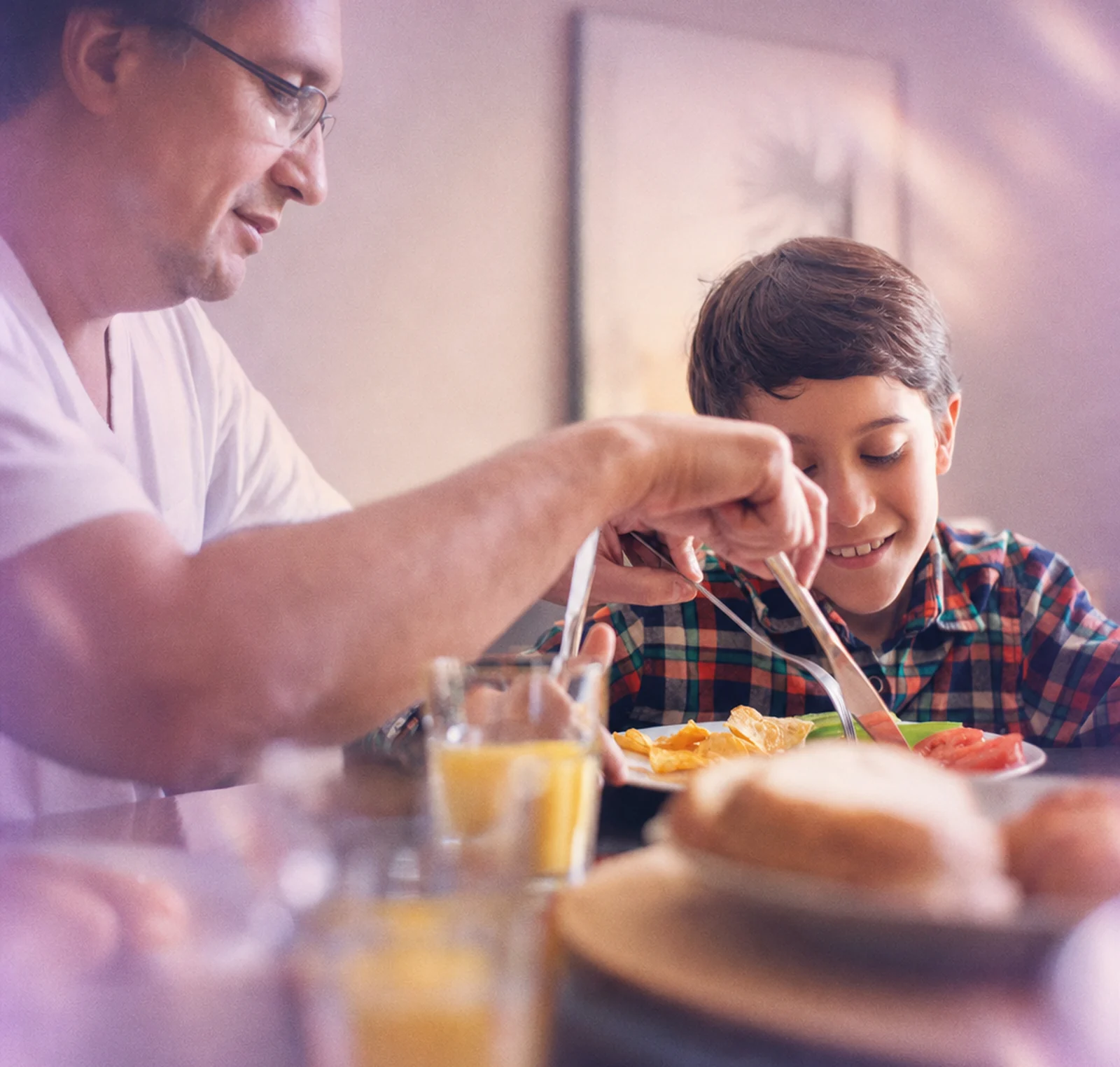 A parent and child sharing a meal at the table