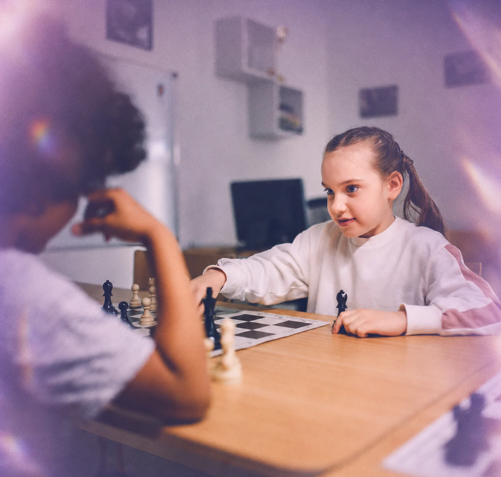 Two children playing a board game together
