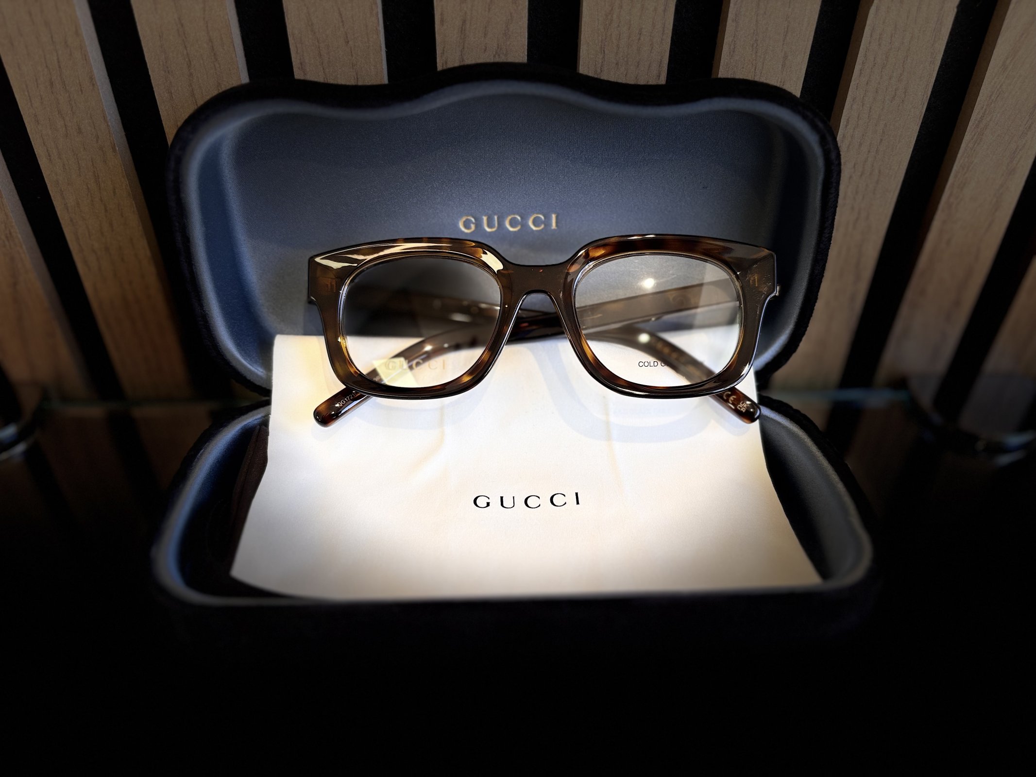 Gucci tortoiseshell eyeglass frames displayed in an open Gucci eyewear case