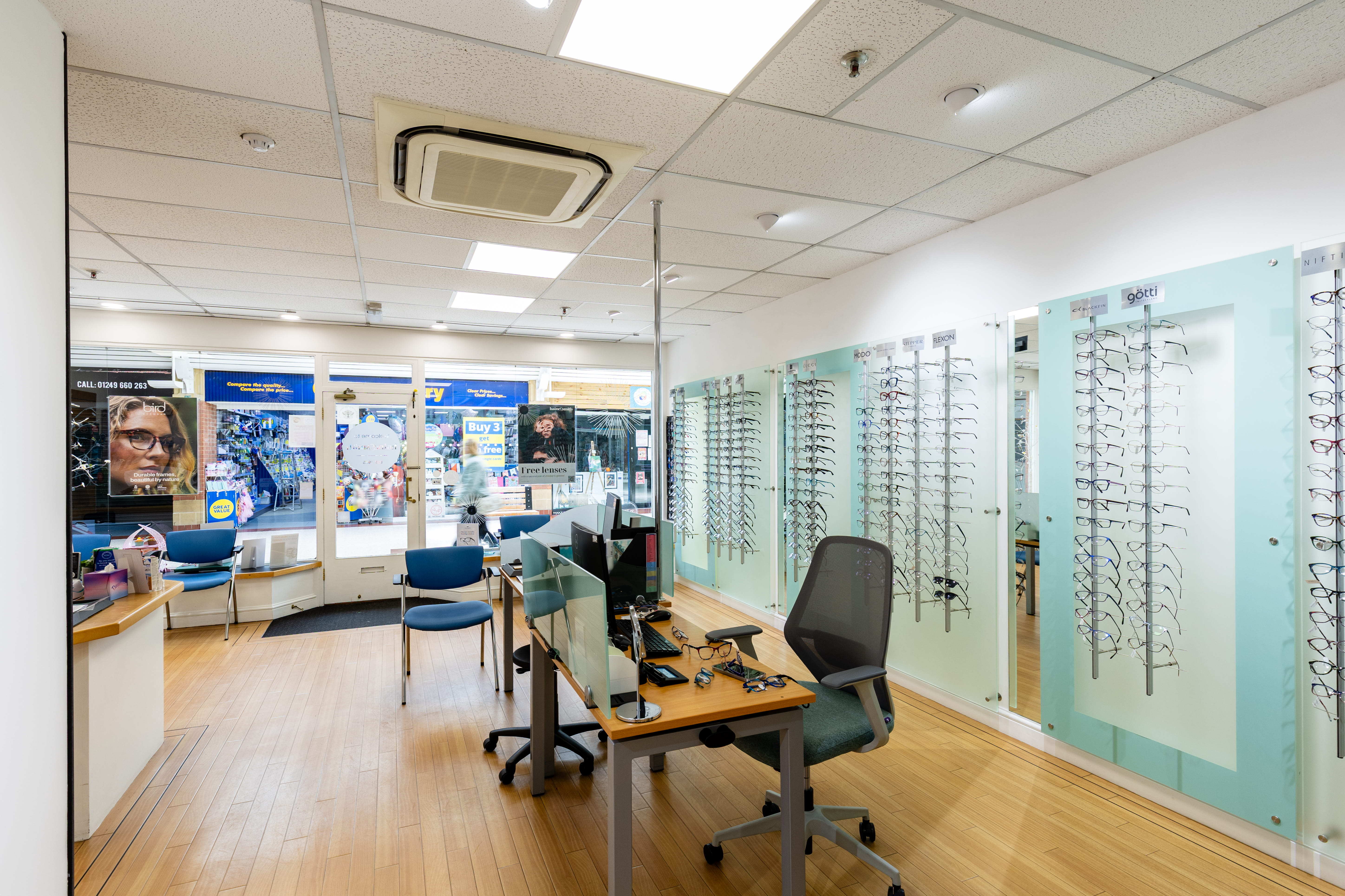 Modern Haine & Smith Opticians practice interior featuring consultation desks, eyewear display walls, patient seating, and a bright retail space showcasing prescription glasses and sunglasses