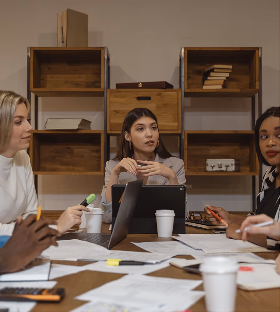 A group of people sitting around a table.