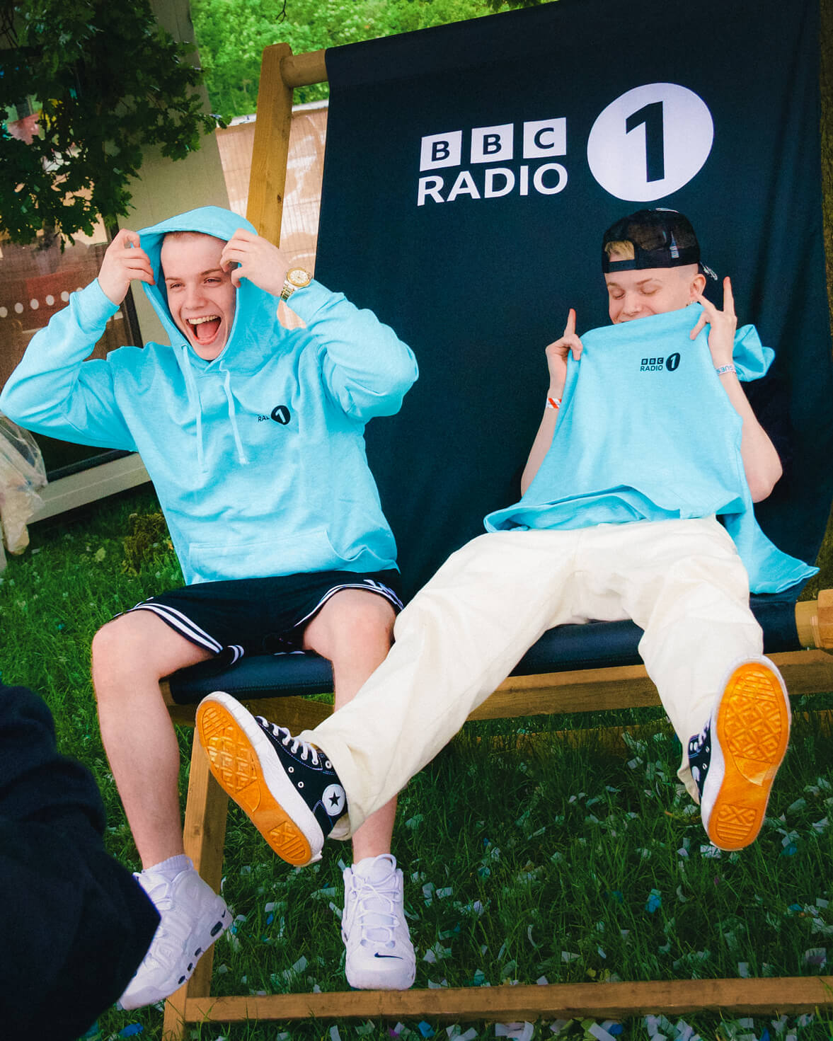 Social media influencers TheSharpTwins sitting on a photo opportnity chair at Radio 1's Big Weekend