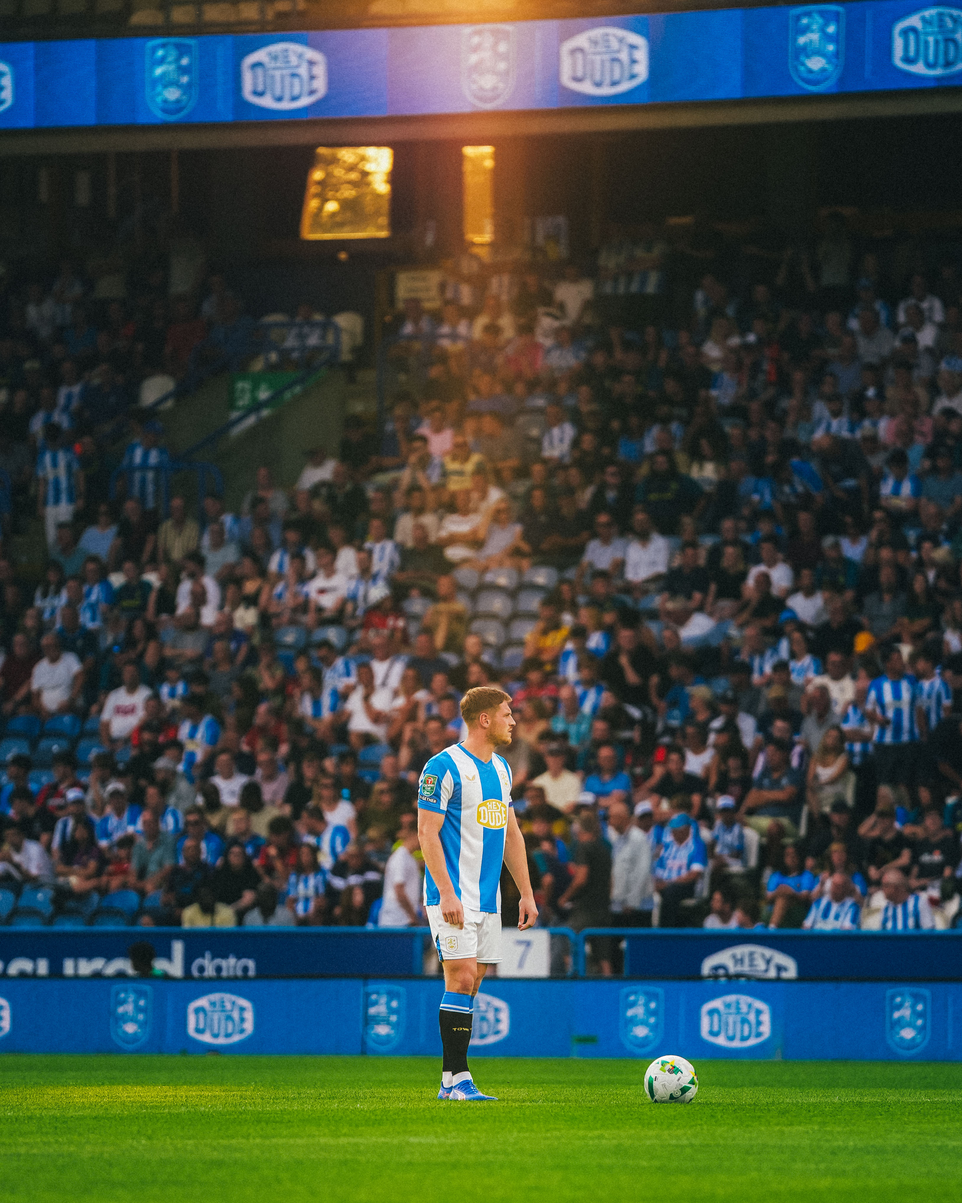 Ben Wiles stands ready to kick of the game with a beam of golden sunlight 