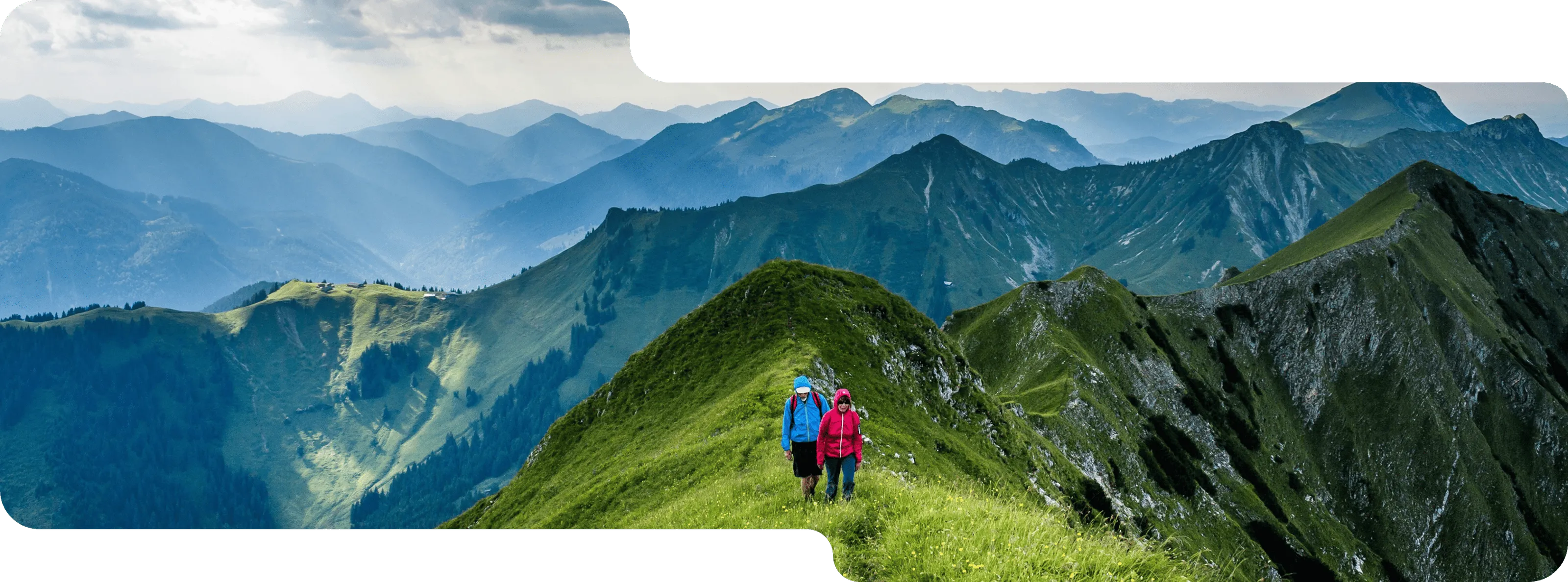 Two hikers on a mountain ridge representing GovEVA’s ESG and sustainability guidance from basecamp to boardroom.