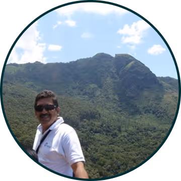 Portrait of a person standing outdoors with hills in the background