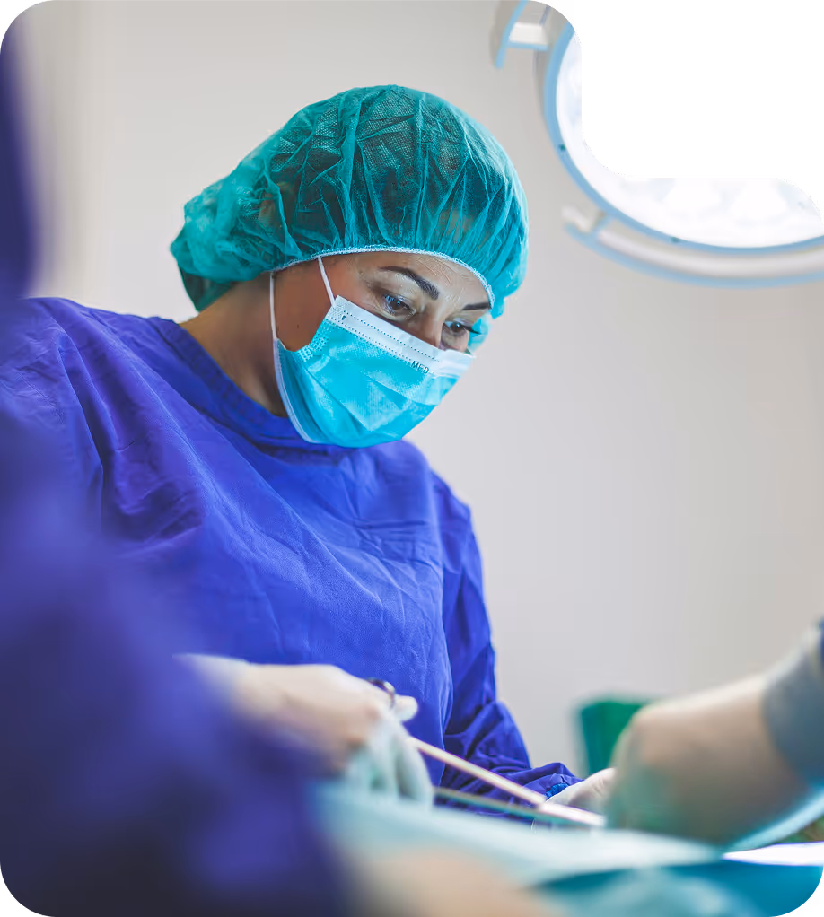 Medical professional in protective gear using lab equipment