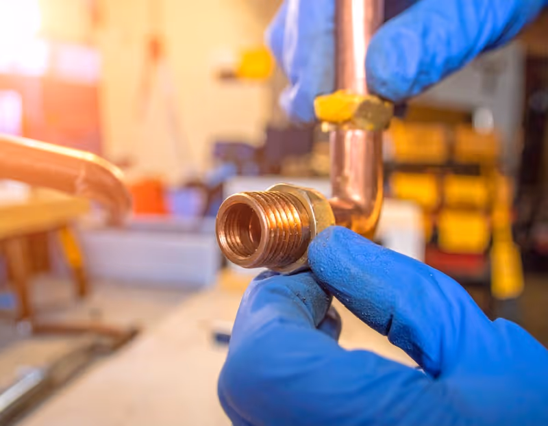 Close-up view of plumbing repair work on copper pipes in Orlando