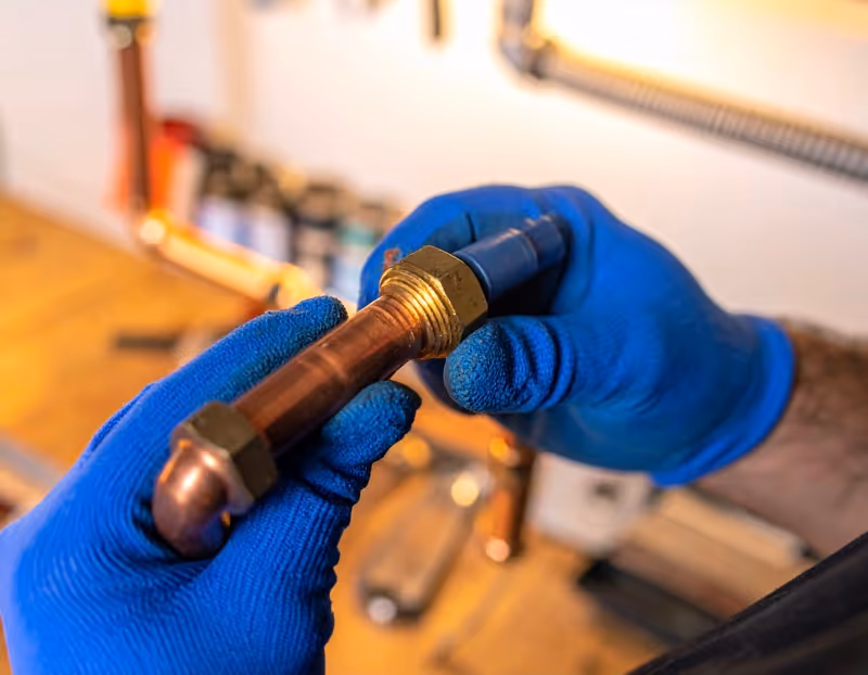 Licensed plumber repairing copper water line in Orlando home