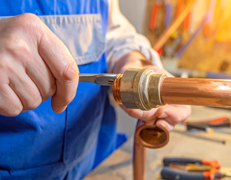 Professional pipe repair Orlando services by Brightwater Plumbing technician inspecting damaged residential plumbing