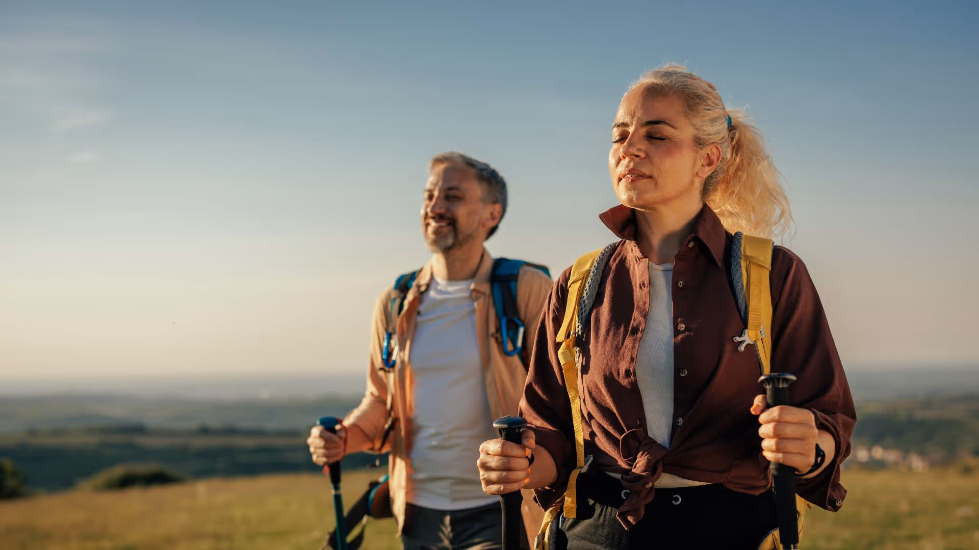 A man and woman hiking, relieved and mobile