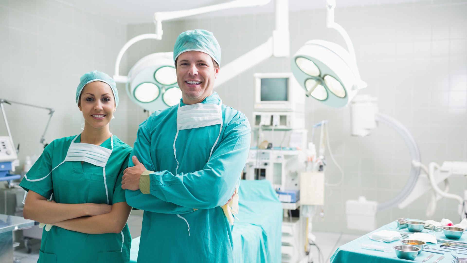 Two private surgeons in surgery room smiling