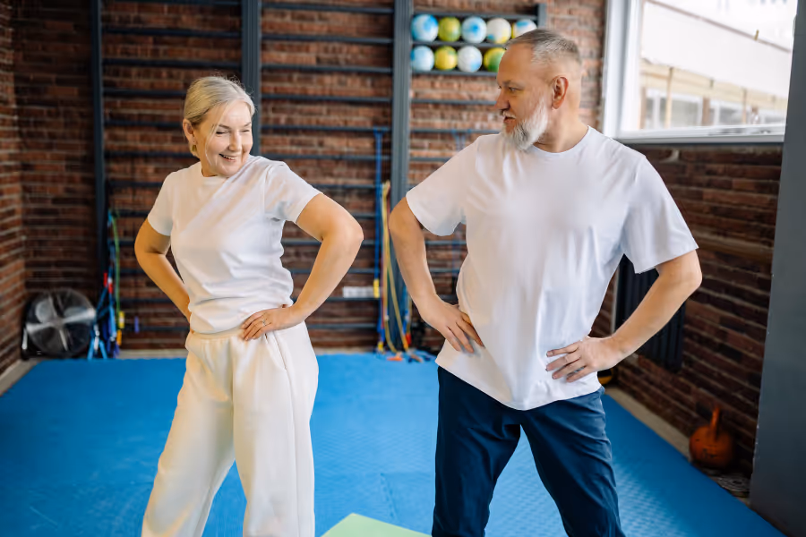 older couple posing in physio gym