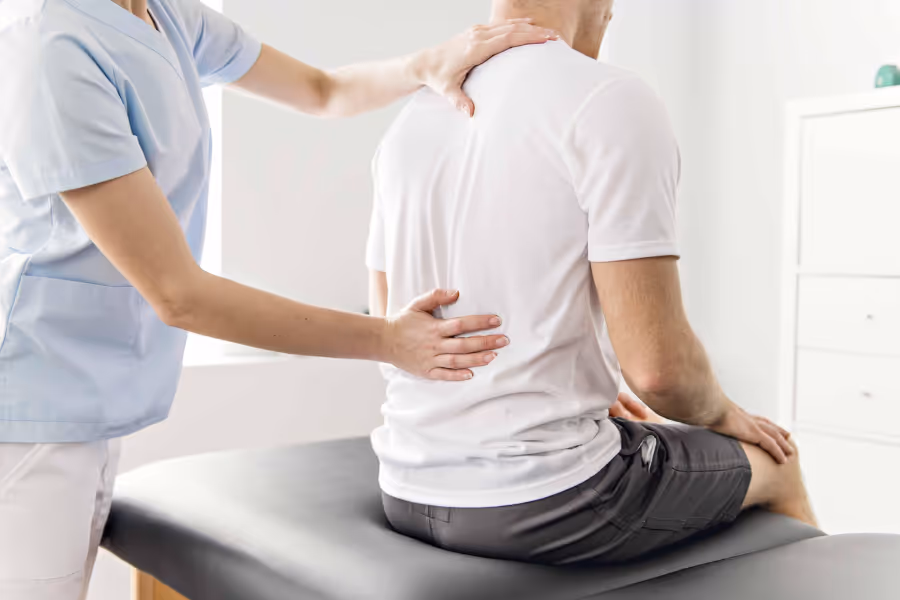 Older patient receiving hip diagnosis on a medical table