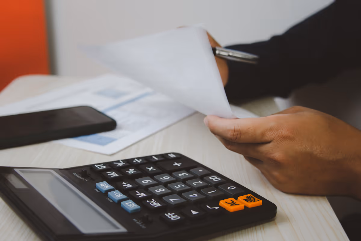 Canadian doing their taxes using a traditional calculator