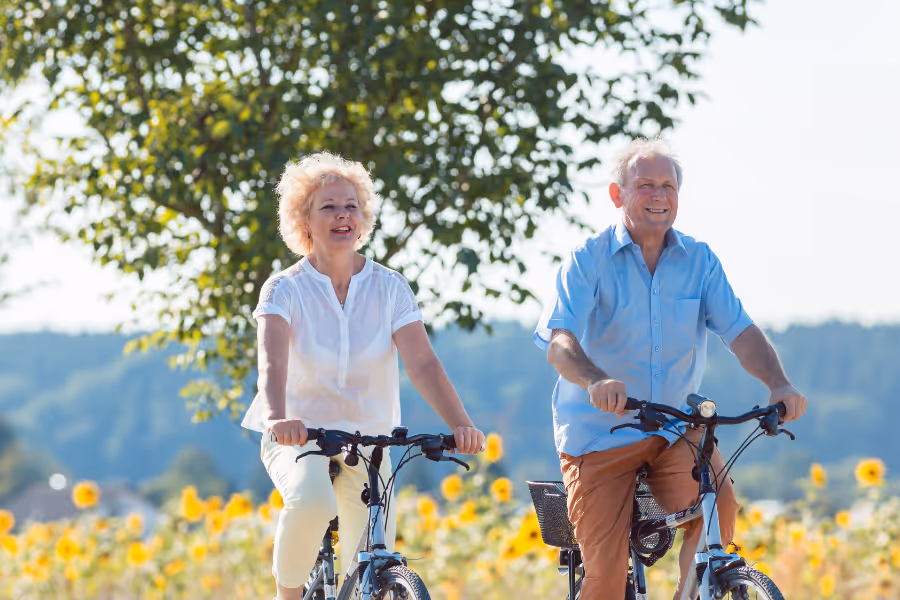 Couple enjoying bike ride in the sun without hip pain