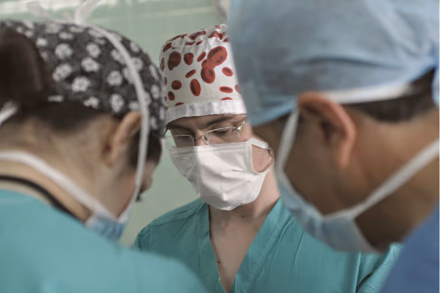 Three surgeons mid-procedure