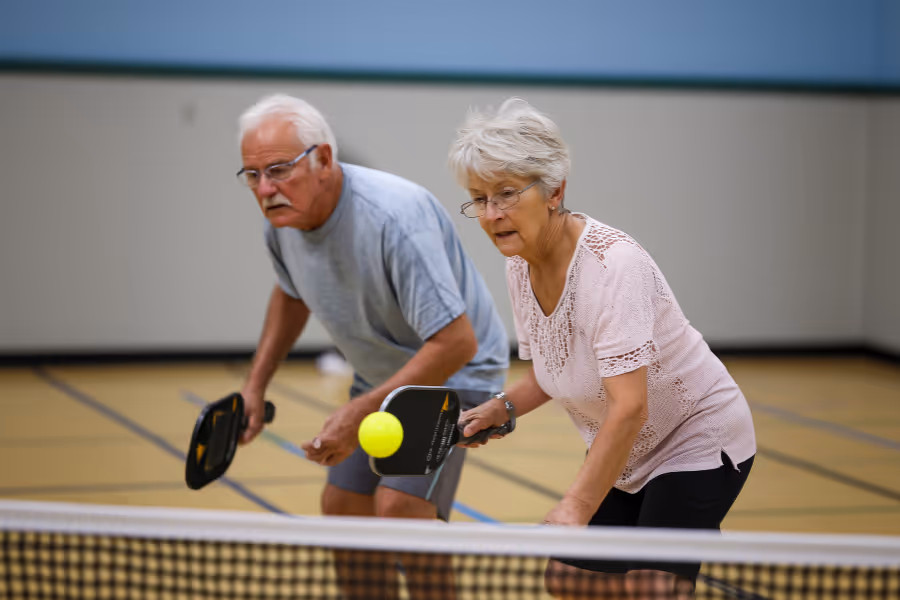 Older couple playing pickle ball