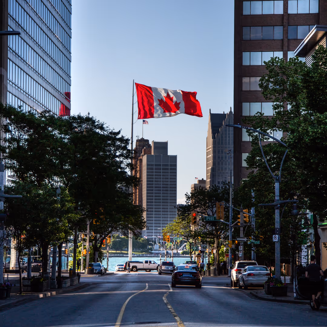 Photo of downtown street, canada flag in the background