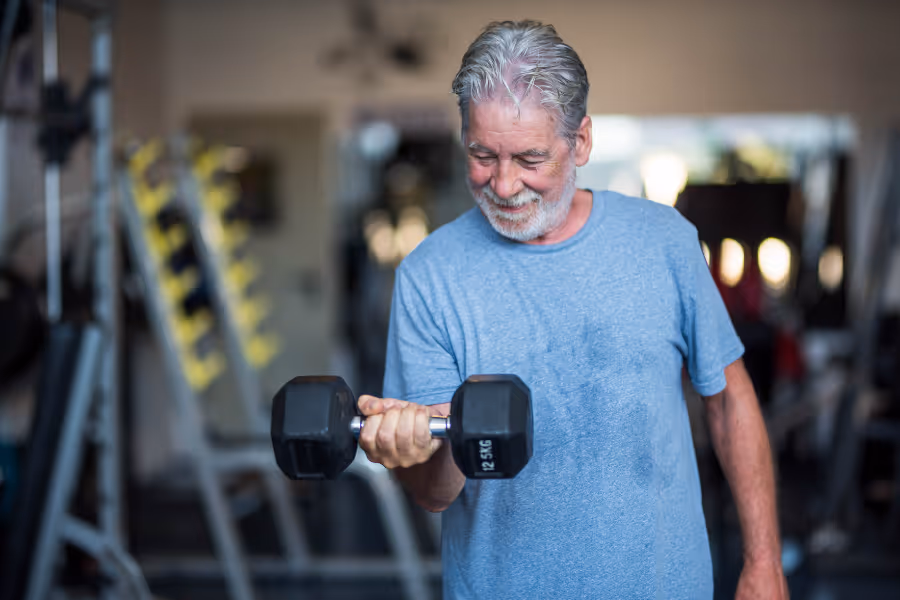 Older man lifting dumbell using a healthy wrist