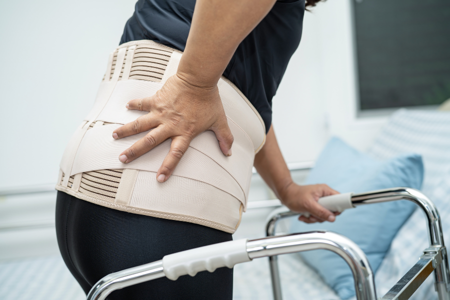 Woman wearing a brace post-spine surgery