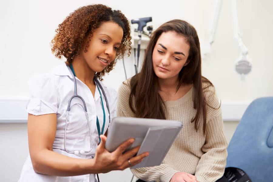Young female patient consulting a nurse about hip pain
