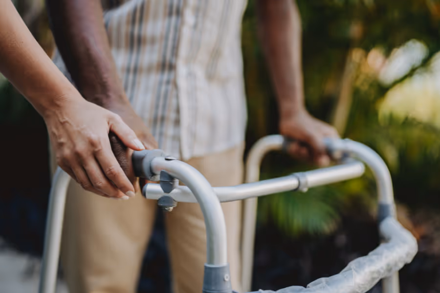 Male patient walking with walker assistance