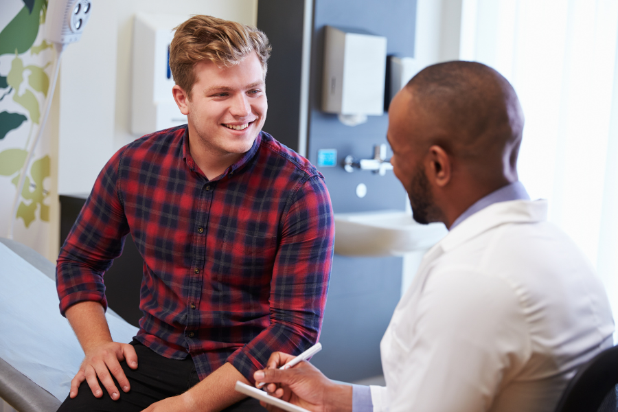 Male patient consulting with male urologist in clinical setting