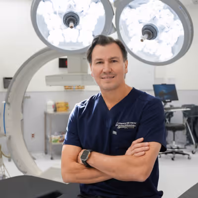 Yves LaFlamme seated on surgical table at Hip and Knee Clinic