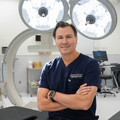 Yves LaFlamme seated on surgical table at Hip and Knee Clinic