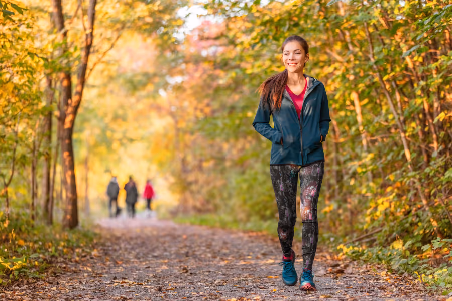 Woman walking confidently post-urinary fistula repair surgery