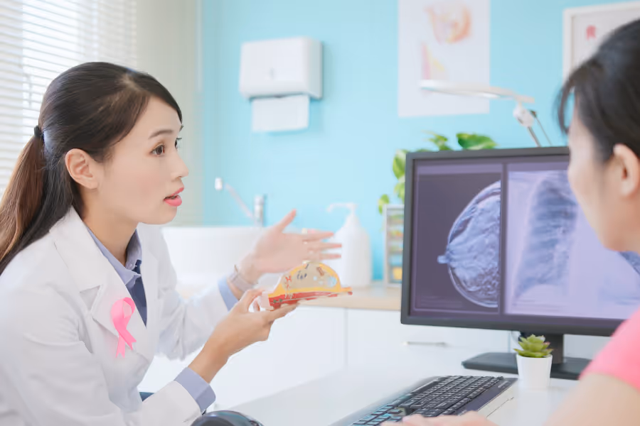 Surgeon consulting with patient regarding breast cancer screening