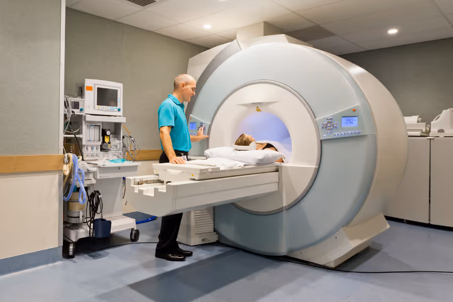 Radiologist discussing CT scan procedure with the patient inside of the CT machine