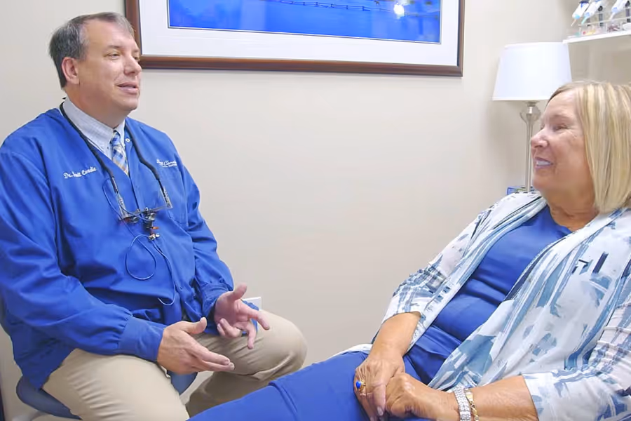 Male surgeon consulting with older female patient about hip replacement