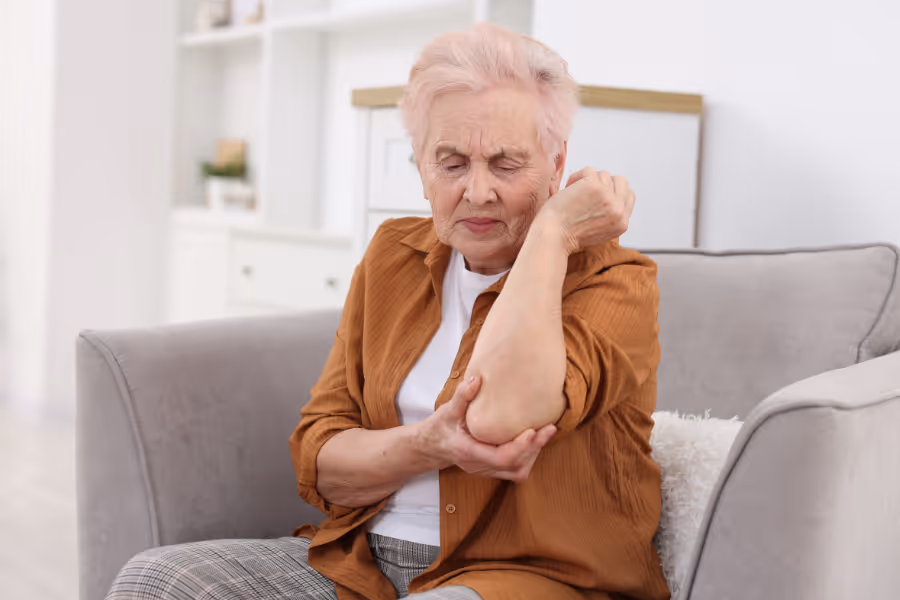 Older woman with visible elbow pain