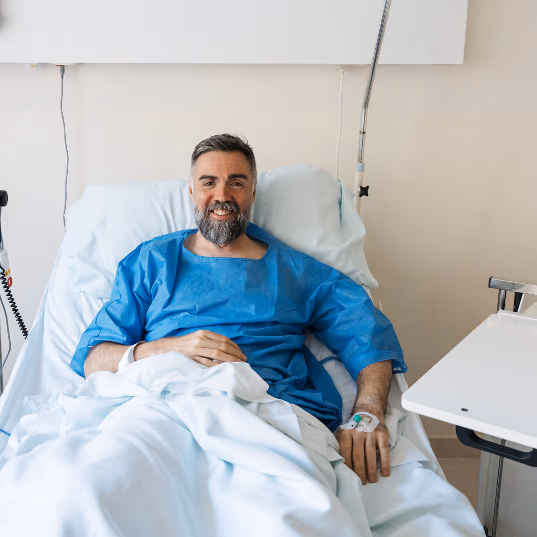 Male patient smiling in post-surgery recovery room