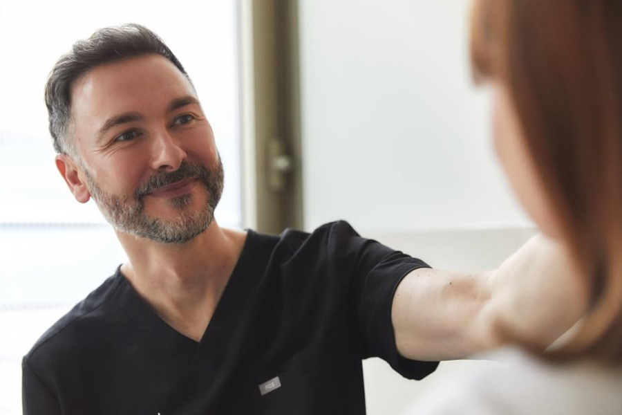 Private podiatry surgeon consulting with female patient
