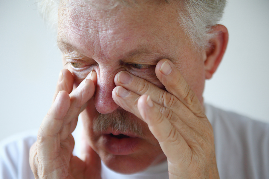 Older man suffering from chronic nose congestion