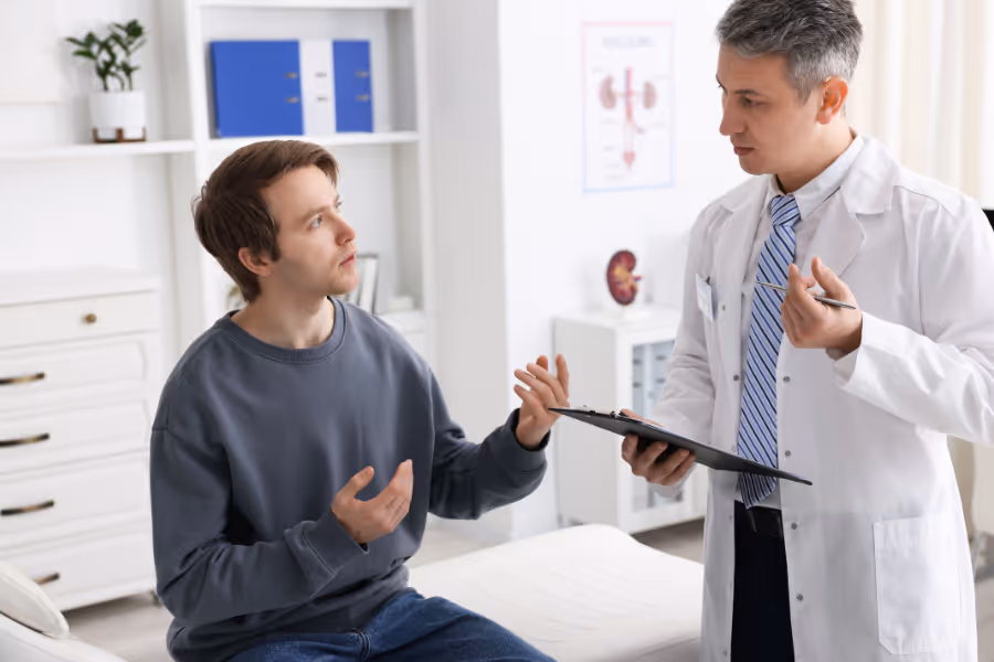 Young man consulting with private surgeon about peyronie's disease