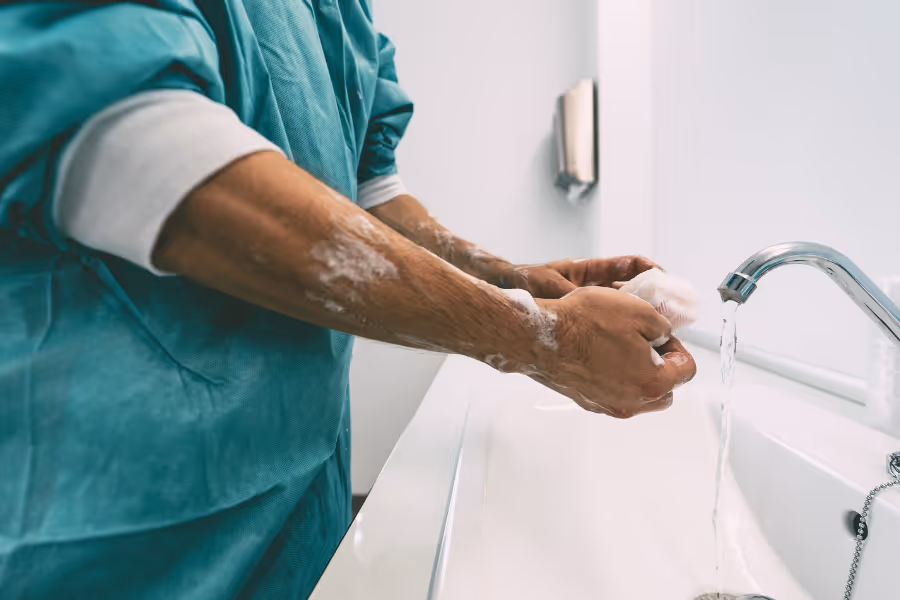 Urologist washing their hands before surgery