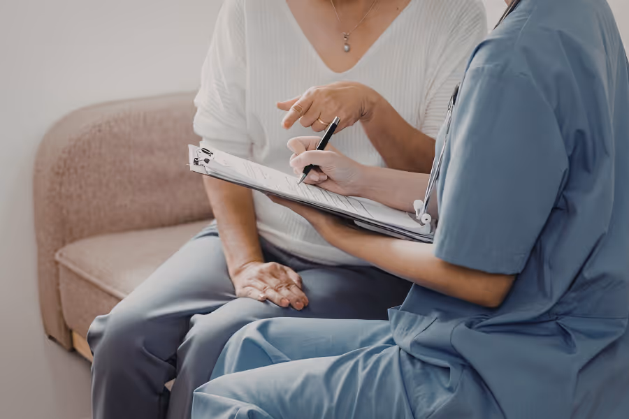 Older female patient consulting with cosmetic surgeon for breast augmentation surgery
