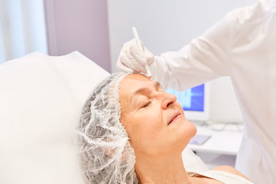 Older female patient being prepped and marked for facelift