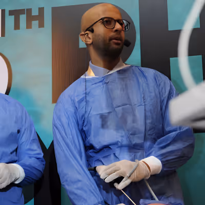 Dr. Andrew Thamboo dressed in surgical scrubs 