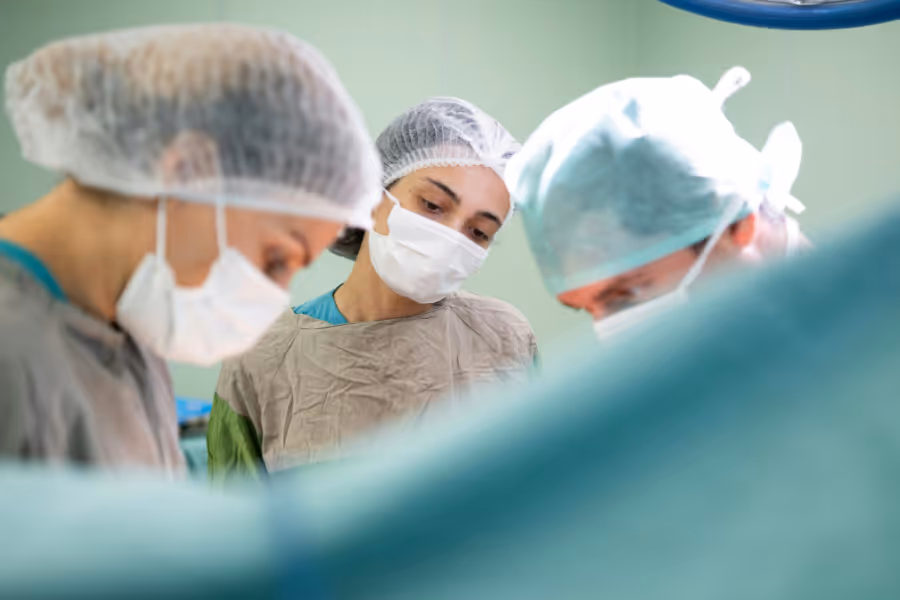 Team of surgical staff performing a labiaplasty