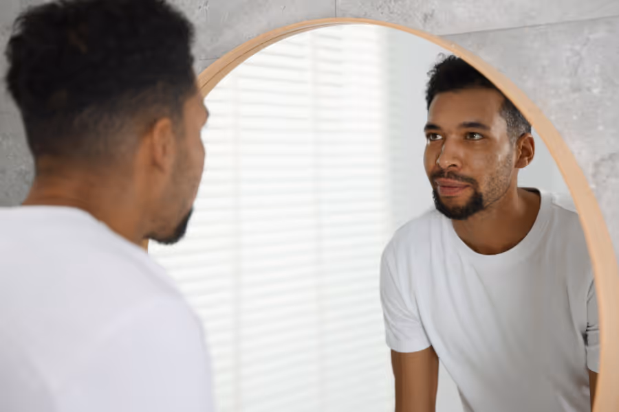 Confidence looking in the mirror after gynecomastia surgery