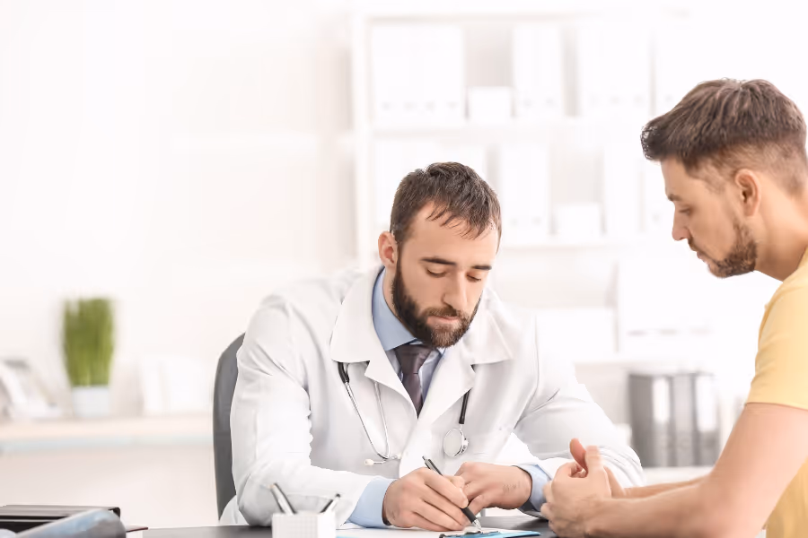 Cosmetic surgeon in a consultation with male patient for gynecomastia