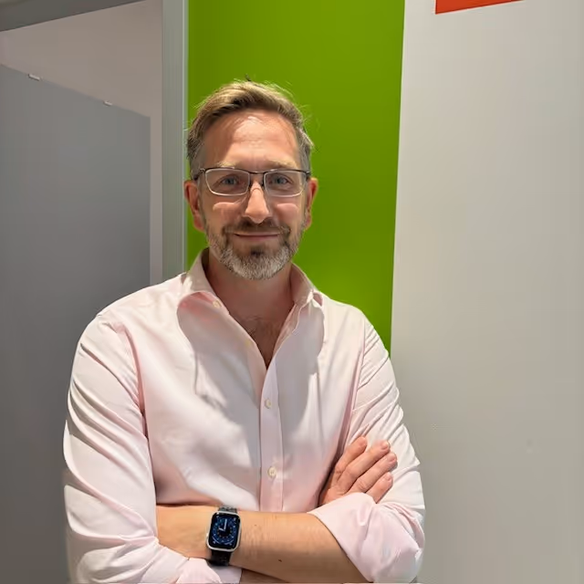 Dr. Paul Hindle, leaning casually on a wall