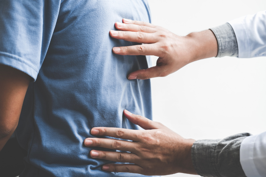 Surgeon examining patient's back for spine surgery